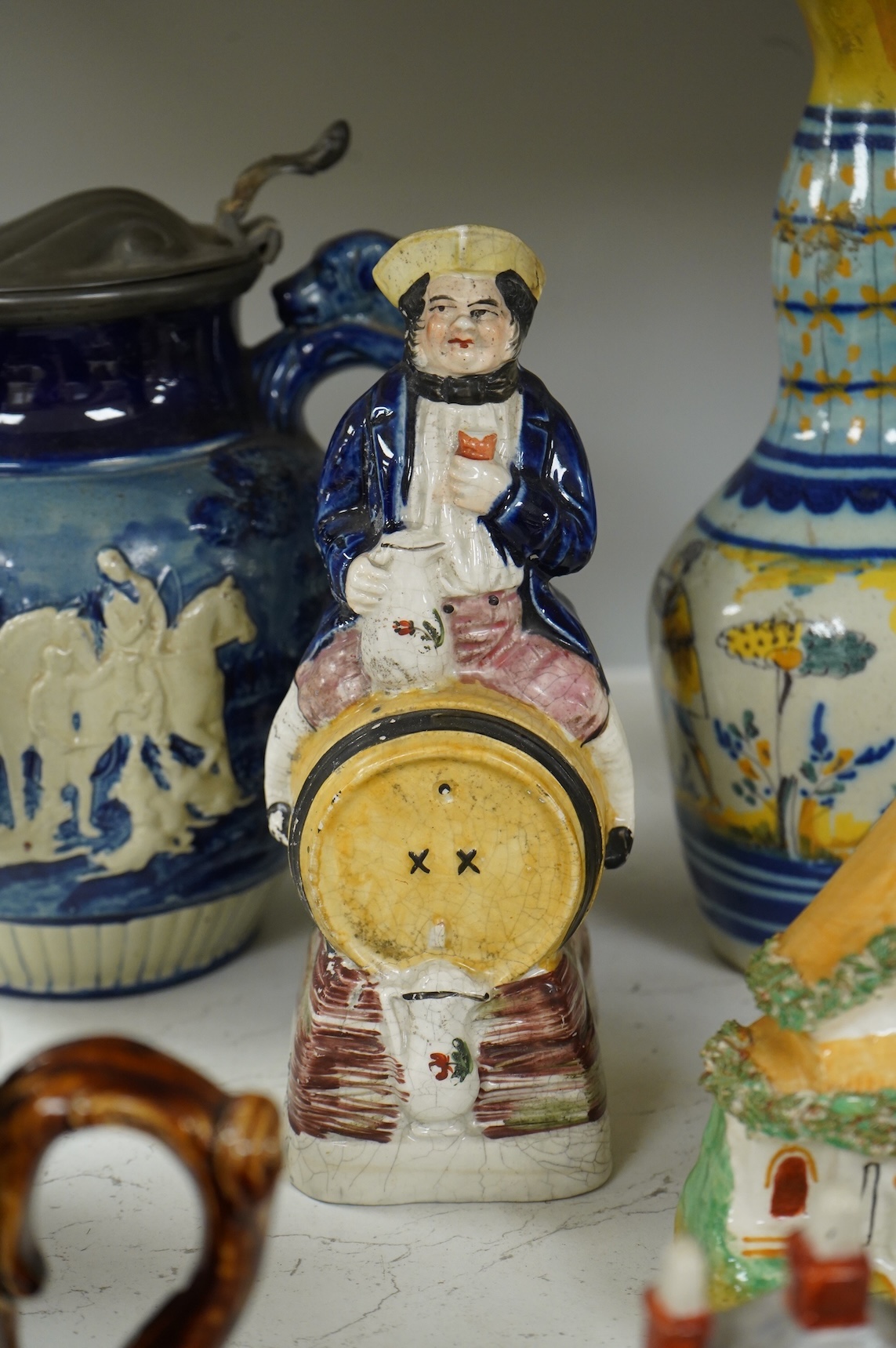 A group of various Victorian Staffordshire pottery models of cottages and various figure moulded vessels together with an Italian maiolica ewer, tallest 25cm